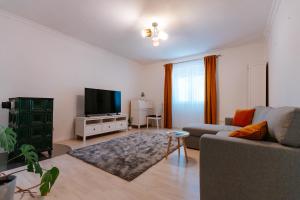 a living room with a couch and a flat screen tv at Kis-Duna Lak in Esztergom