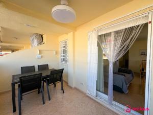 a dining room with a table and chairs and a bedroom at Respiro di Levante in Oropesa del Mar +33 photos