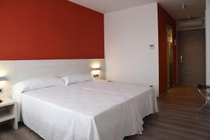 Postel nebo postele na pokoji v ubytování Hotel Julimar