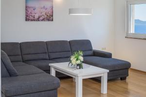 a living room with a couch and a coffee table at Casa Moderna - New Spacious Apartments in Lokva Rogoznica +51 photos