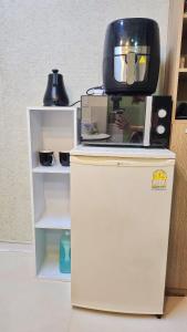 a television sitting on top of a refrigerator at Manu Stay in Seoul +7 photos