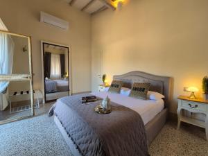 a bedroom with a bed and a large mirror at Residenza d'Epoca CAVALIERE - Romantic Rooms in Bibbona