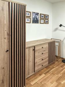 a room with a wooden dresser and a lamp at Andrea 7 by SMR Rauris Apartments - inc Spa and near Gondola in Rauris