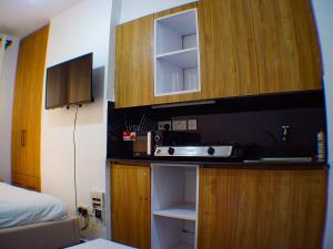 a bathroom with a sink and a cabinet with a mirror at Cozy Homes in Nairobi