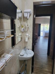 a bathroom with a sink and a hallway at Casa Ratiu 3 Stele Airport Bucharest Therme Bucharest in Baloteşti
