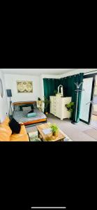 a living room with a couch and a table at East Bridgford Summerhouse Inc Spa and Treatments in East Bridgford