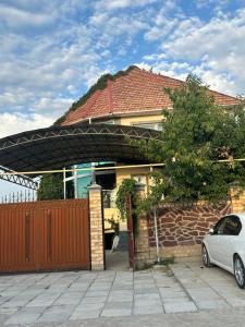 a house with a car parked in front of it at Mama Gulya in Bishkek