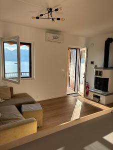 a living room with a couch and a stove at Appartamento Pelèr in Pai +8 photos