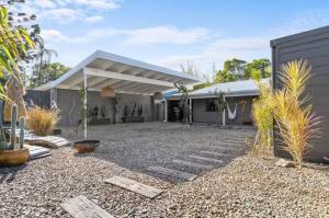 a house with a gravel yard in front of it at Desert Flame - Couples Retreat near the Beach in Marcus Beach