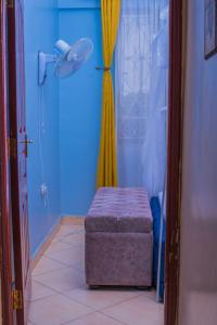 a bathroom with a shower with a ottoman in a room at Bay Loft Apartment 1 BR Netflix n Internet in Homa Bay