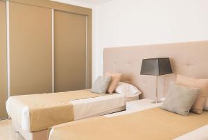 a hotel room with two beds and a lamp at Exclusivo Atico en La Cala Golf in La Cala de Mijas +24 photos
