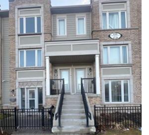 a building with a clock on the front of it at Private, Secure, Immaculate & Cozy Room in Brampton