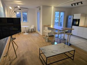 a kitchen and living room with a table and chairs at The Blue Sky Haven 2 - 5min to Disneyland in Serris +32 photos