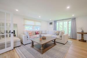 a living room with a couch and a table at Tranquil Waterfront Getaway in Bourne