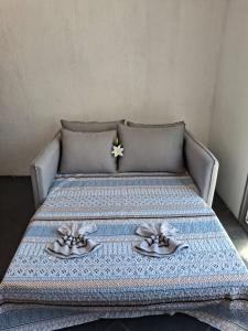 a bed with two plates of food on it at APARTAMENTO de 1 QUARTO JARDIM CAMBURI ,VITÓRIA-ES in Vitória