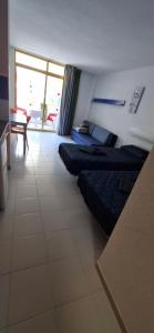 a room with three beds in a room with a table at Loft in Salou Residence Inter 2 in Salou