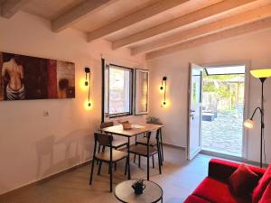 a living room with a table and chairs and a couch at Alegria apartments in Gaios