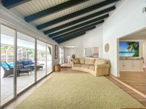 a living room with a couch and a table at Siesta Key Paradise, Vacation Pool Home, Near Beach, Restaurants and More in Sarasota