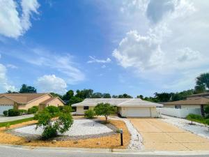 a home in a subdivision with a driveway at Siesta Key Paradise, Vacation Pool Home, Near Beach, Restaurants and More in Sarasota