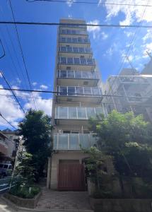 a tall building with a red door in front of it at Otsuka No3 Mansion#JR Yamanote Line Otsuka in Tokyo
