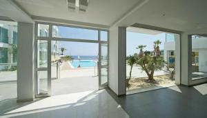 an empty house with a view of the ocean at Too Coool 1 Bedroom Apartment Coralli Resort in Protaras +10 photos