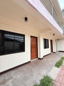 a house with a wooden door and a patio at JL Suites Calbayog in Calbayog