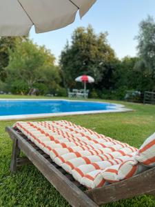 a mattress sitting on a bench next to a pool at Quinta da Maínha - Charming Houses - Escape to Nature in Braga