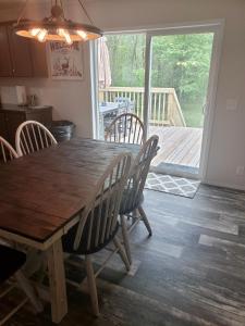 a wooden table and chairs in a kitchen with a deck at Hidden meadow in Pullman