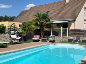 a swimming pool in front of a house at La Régence Ch 2 in Brette-les-Pins