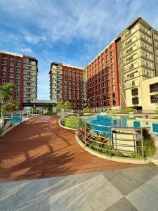 a view of two apartment buildings with a swimming pool at Primeworld District Condoresort 15mins2airport in Mactan Island