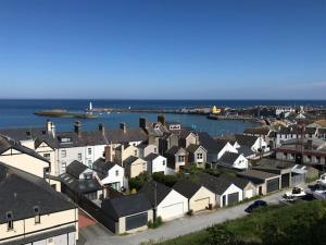 an aerial view of a town with houses and the ocean at The Wee Flat - Donaghadee in Donaghadee