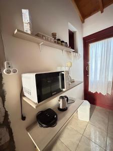 a microwave sitting on a counter in a kitchen at Agapis Apartments in Petra