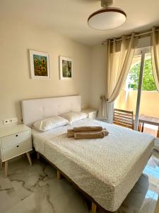 a bedroom with a large bed and a window at Playa Sol 2 in Denia +20 photos