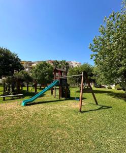 a playground with a slide in a park at Playa Sol 2 in Denia