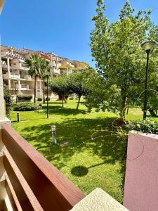 a view of a park with trees and a building at Playa Sol 2 in Denia