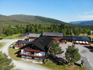 an aerial view of a lodge with mountains in the background at Heia Gjestegård in Grong