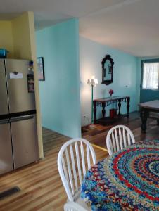 a kitchen with a table and two chairs and a refrigerator at Serenity Now Sunset Beach in Sunset Beach
