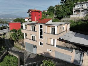 an aerial view of a building with a red house at Lake Retreat Villa in Shkodër +31 photos