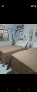 a bedroom with two beds and a window at Casa JB in Chapada dos Guimarães +31 photos