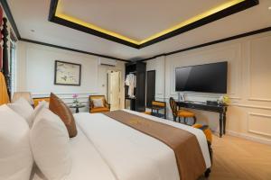 a hotel room with a bed and a flat screen tv at Golden Boutique Hotel in Hanoi +15 photos