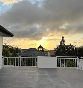 a white fence in front of a house at Devata 68 Private Room VIP in Uluwatu