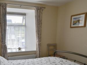 Voodi või voodid majutusasutuse Kerrim Cottage toas