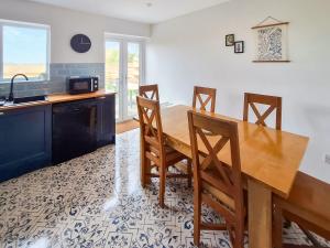 a kitchen with a wooden dining room table and chairs at No 2 Badger Sett-Uk44307 in Lenwade