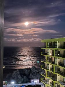 a view of the ocean at night from a building at Nik and dom Alezzi studio in Mamaia Sat/Năvodari