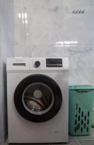 a white washing machine with a bucket next to it at LiRa in Kremasti