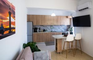 a kitchen with a couch and a table in a room at LiRa in Kremasti