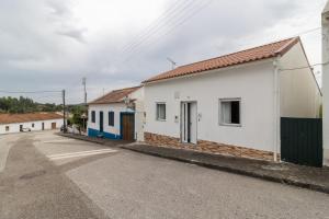 an empty street with two buildings on the side at Villa T4 35km Montargil - Private & Heated Pool in Casal do Anafe de Baixo