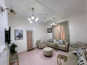 a living room with a couch and a table at بيت السعادة in Salalah