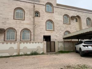 a building with a car parked in front of it at بيت السعادة in Salalah
