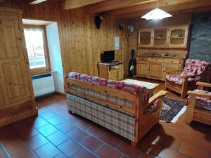 a living room with a couch and a table at La Baita di Savara - nature and silence in Valsavarenche